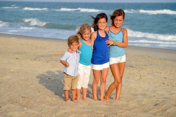 Children smiling at a beach