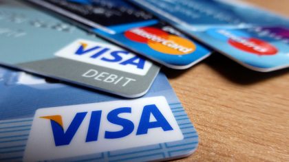 A close up of 4 visa credit cards