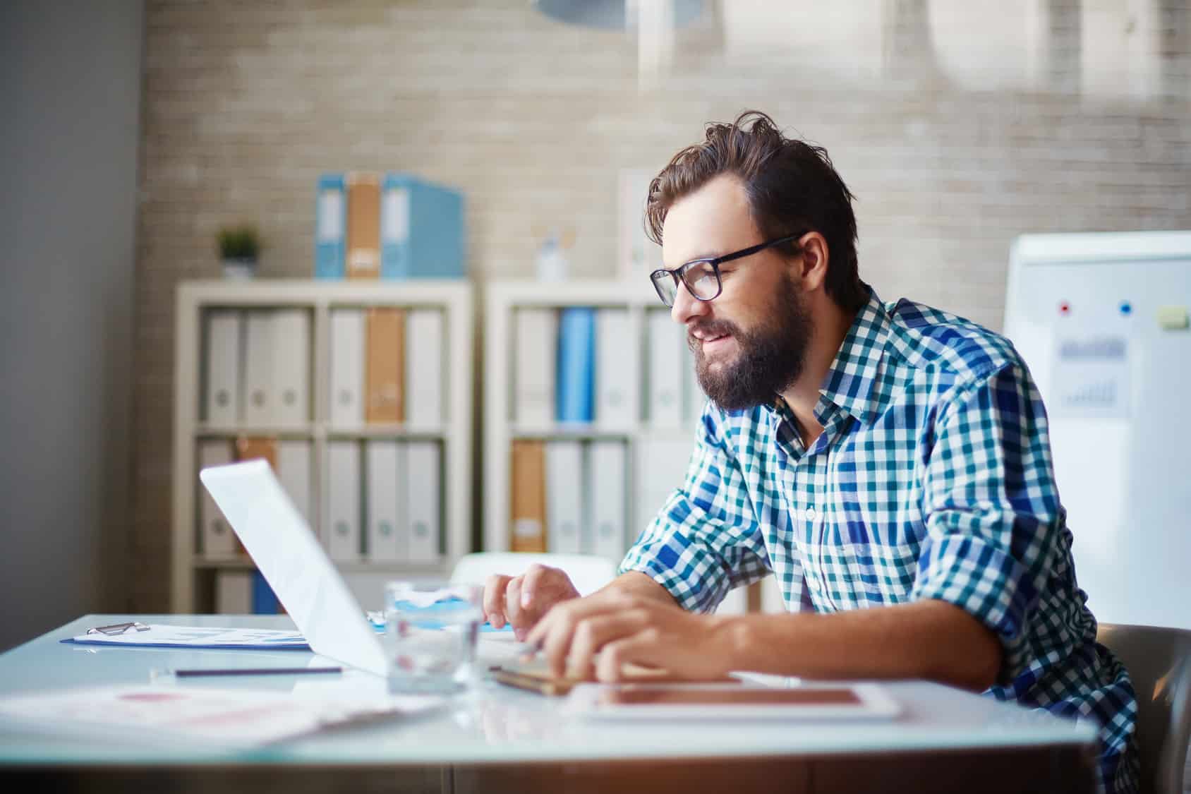 man typing on laptop