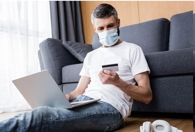 Man wearing mask with credit card