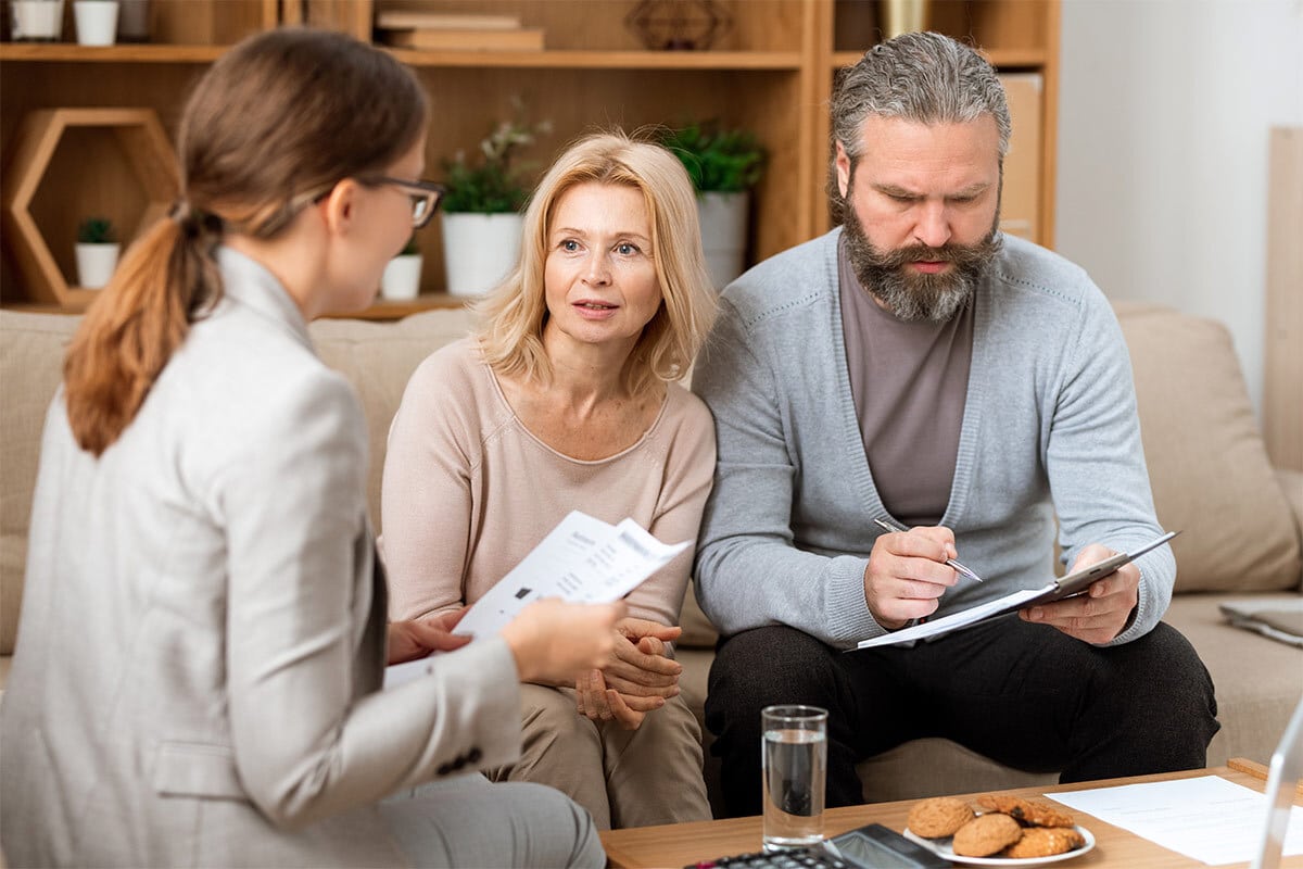 Couple looking at debt management forms