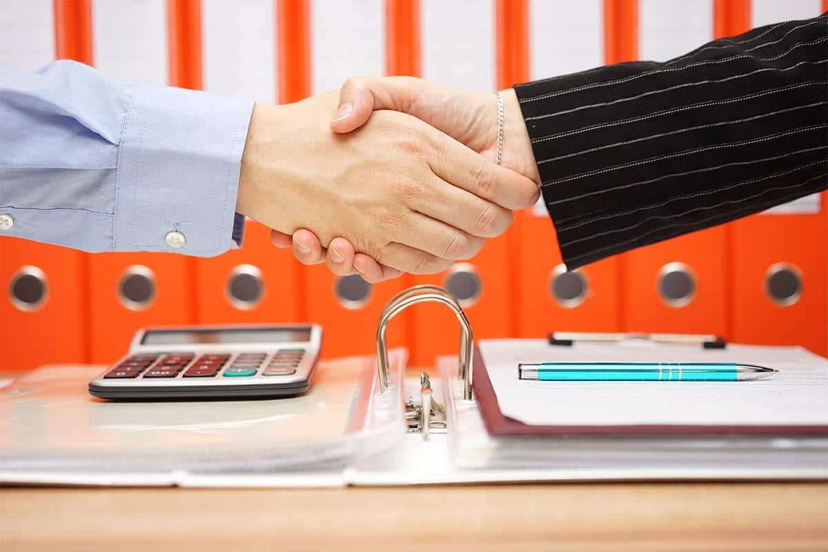 tax advisor is handshaking with satisfied client